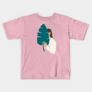 Brunette girl in white with tropical banana leaf Kids T-Shirt